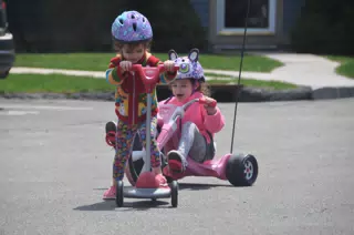 Liesl and Luciana Riding in the Parking Lot