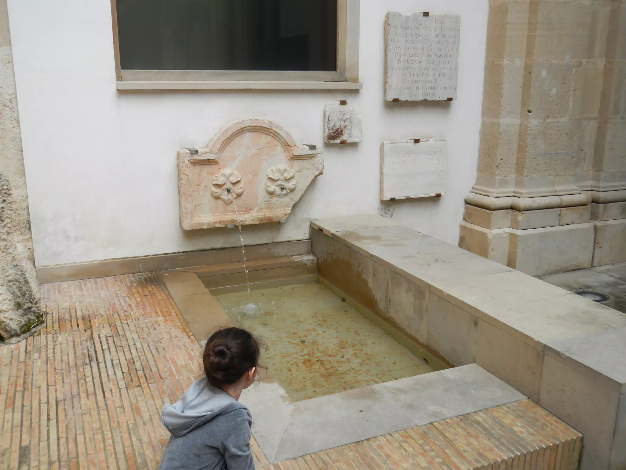 Liesl Watching Fountain in Sevilla Cathedral Courtyard