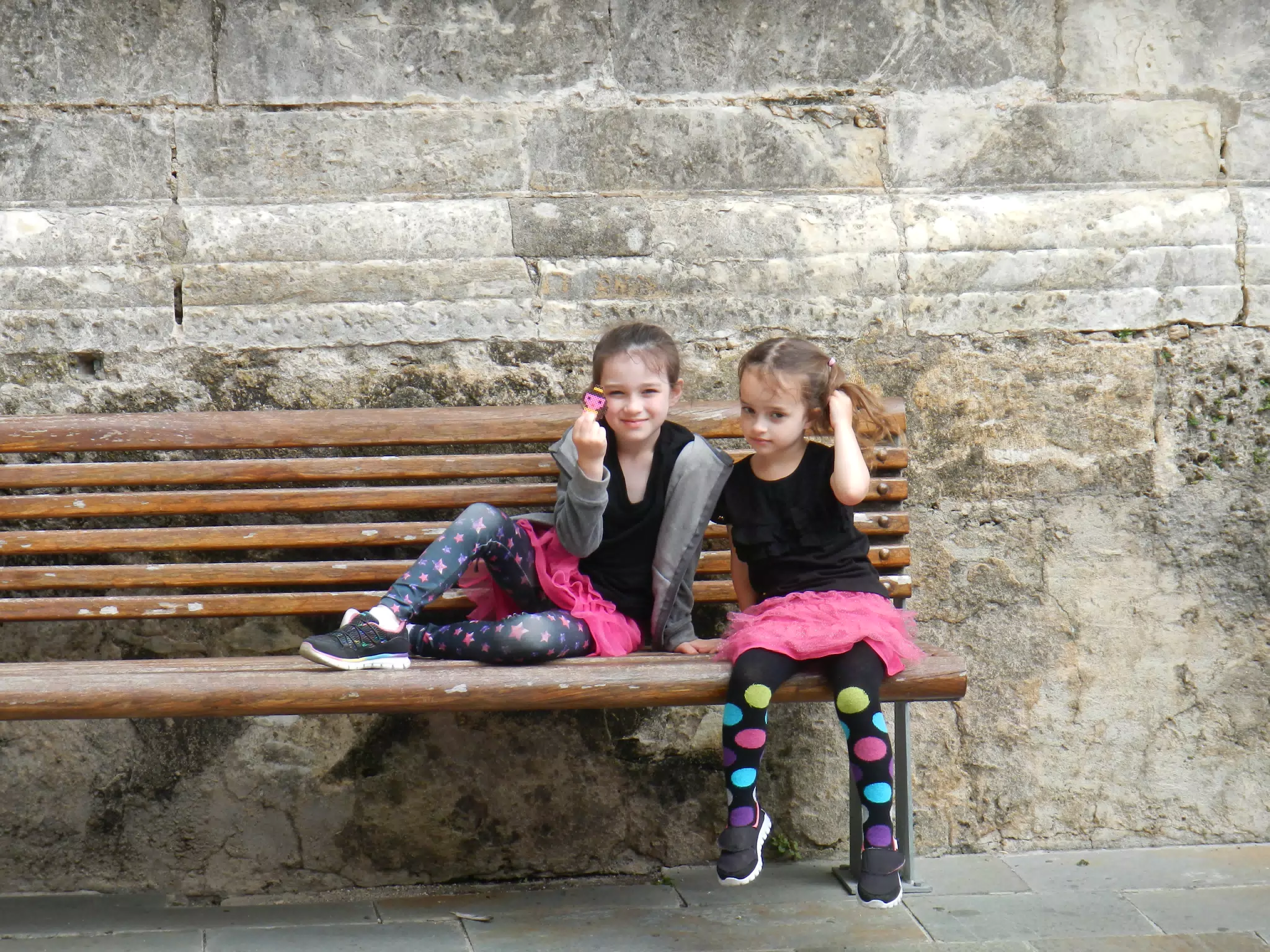 Liesl Showing Plastic Princess Charm on Bench at Sevilla Cathedral