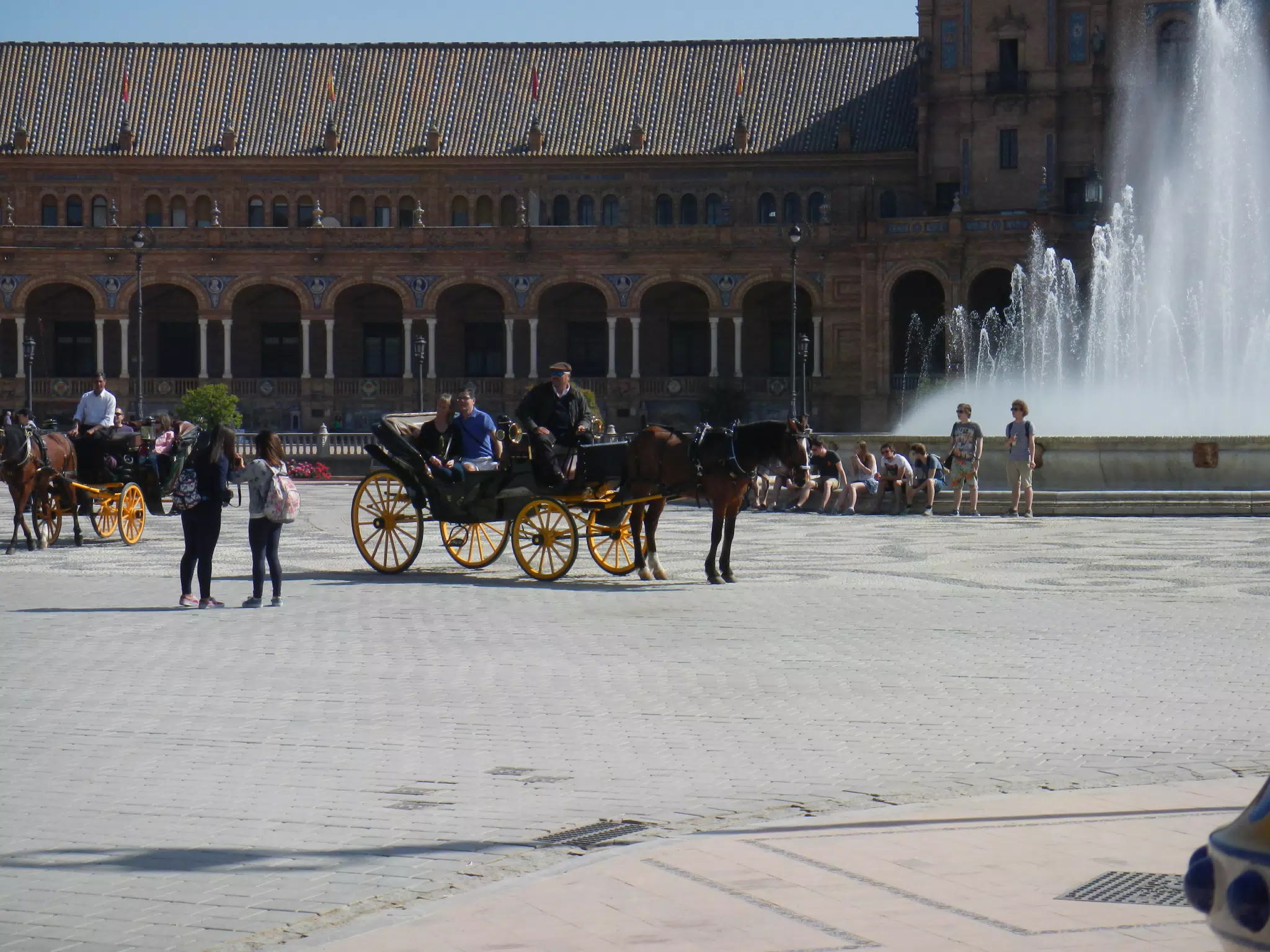 Horse Drawn Carriage in Plaza by Fountain