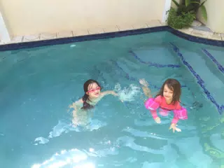 Liesl and Luciana Swimming in the Pool at the House