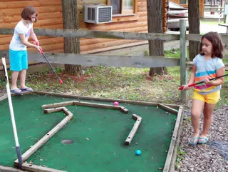 Madeline and Emily Playing Miniature Golf