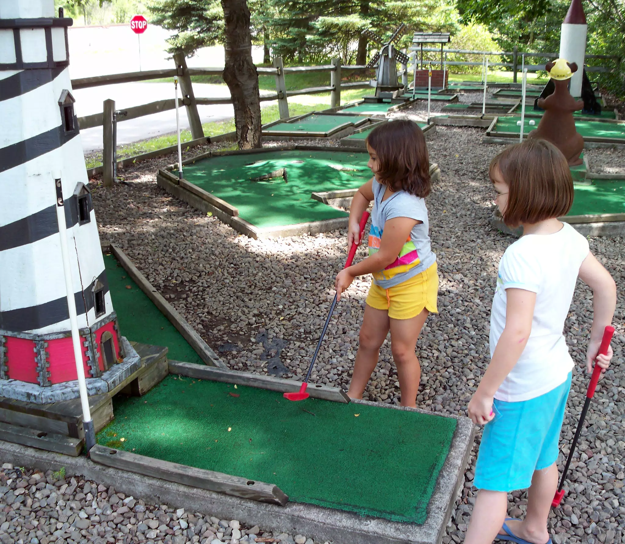 Emily and Madeline Playing Miniature Golf