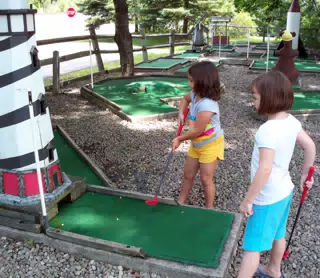 Emily and Madeline Playing Miniature Golf