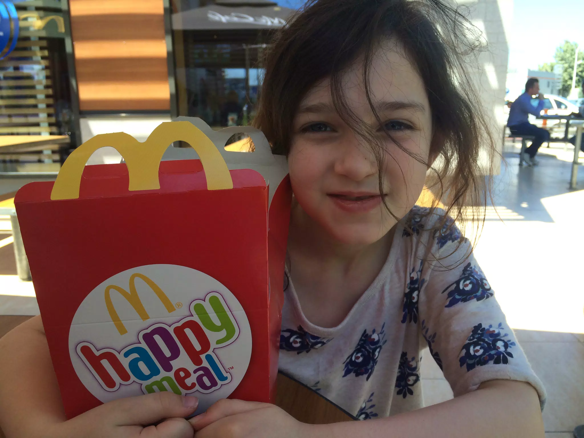 Liesl with McDonald's Happy Meal in Romania