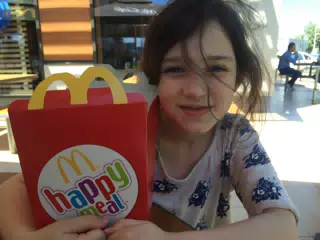 Liesl with McDonald's Happy Meal in Romania