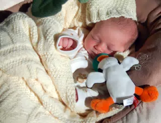Liesl Asleep in Her Swing with Her Penguin