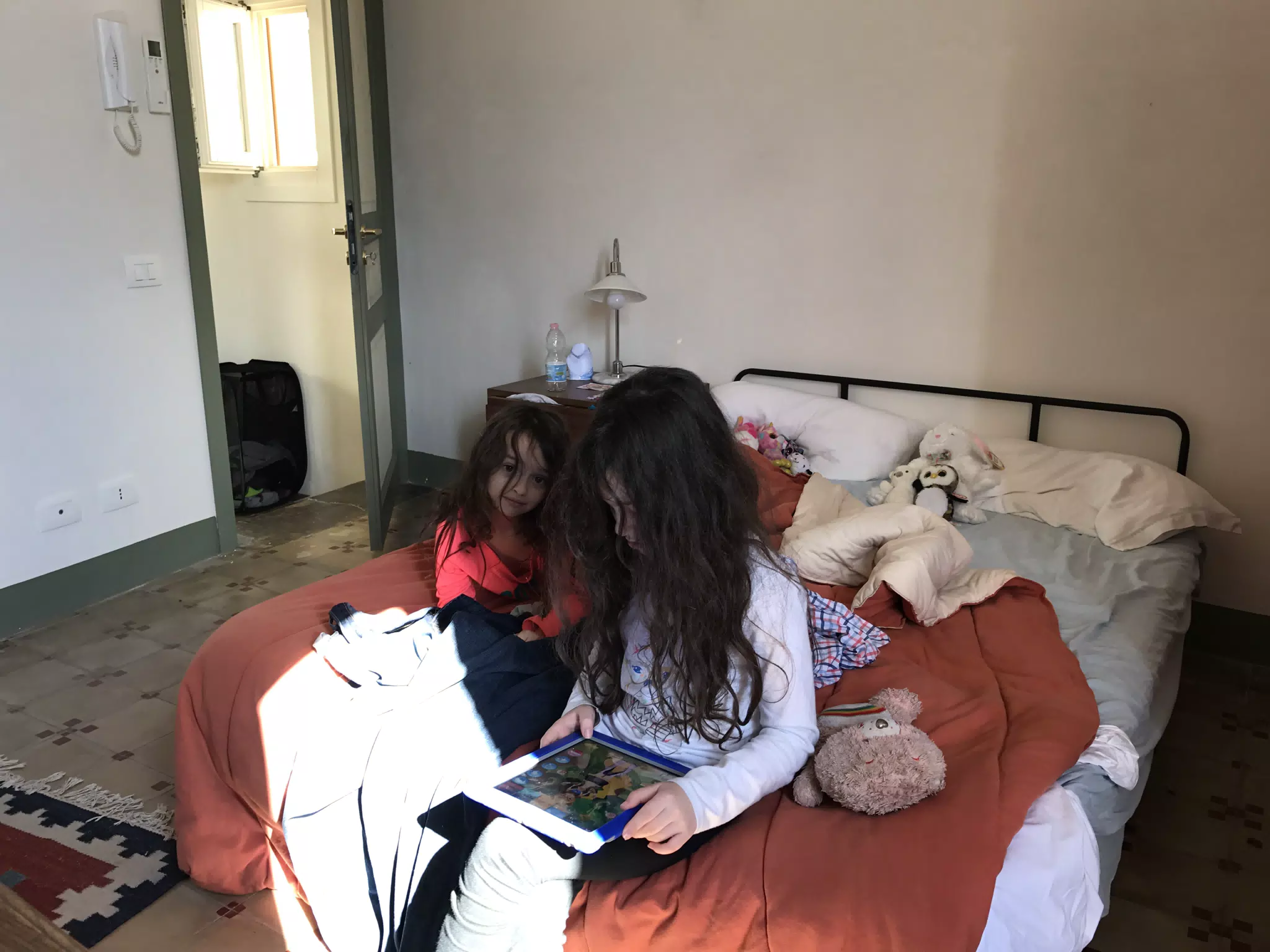 Liesl and Luciana on the Bed in Their Room in Noto