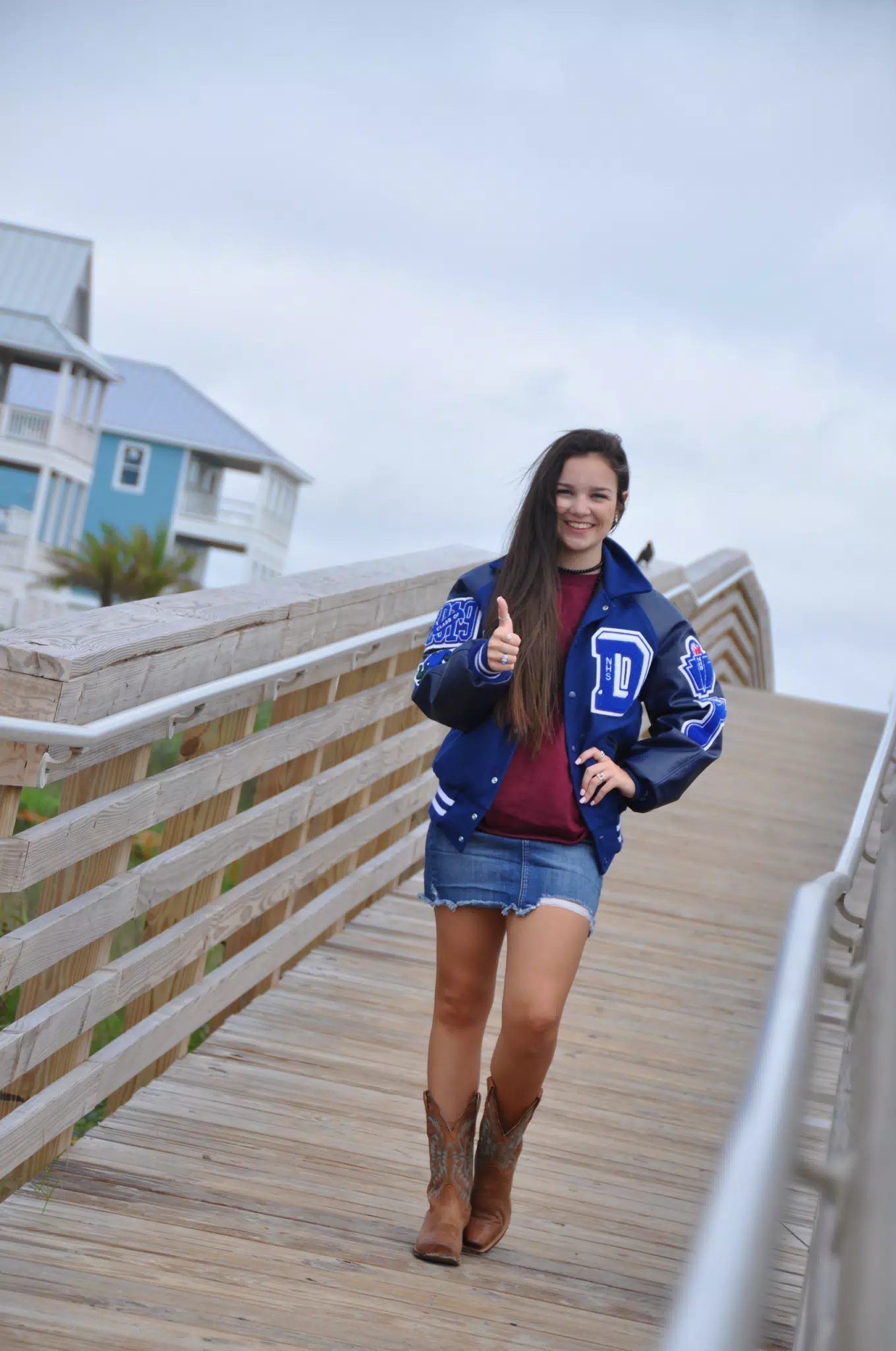 Emily Giving Thumbs Up in Letterman Jacket on Galveston Boardwalk
