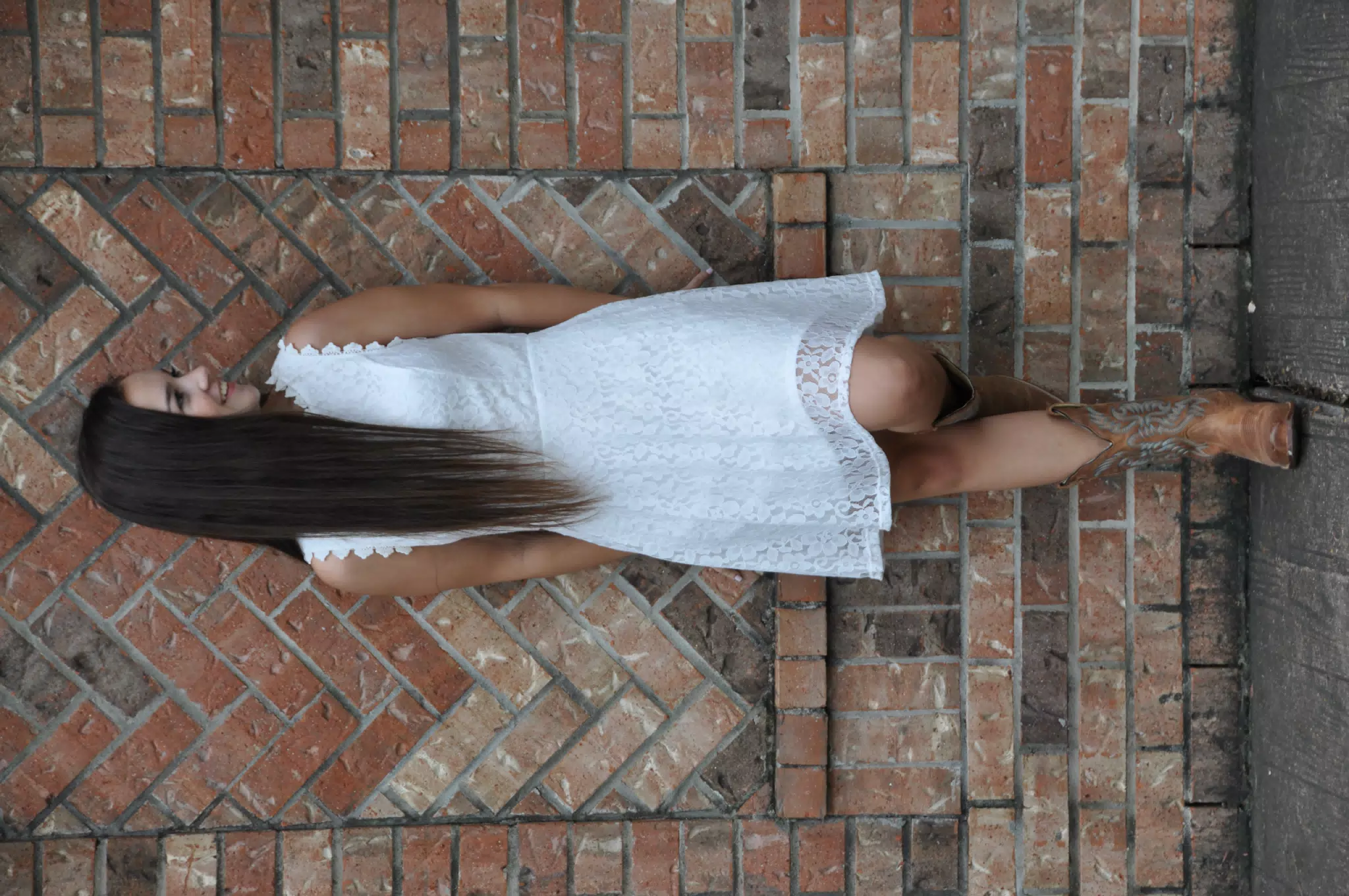 Cowgirl Model in White Dress with Boots on Brick Wall in Texas
