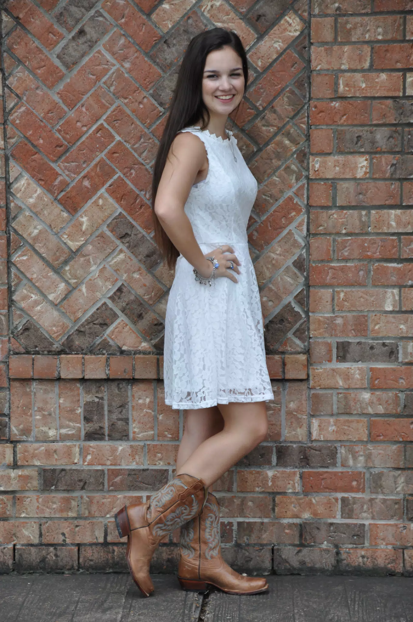 Teen Model in White Dress by Brick Wall in Boots