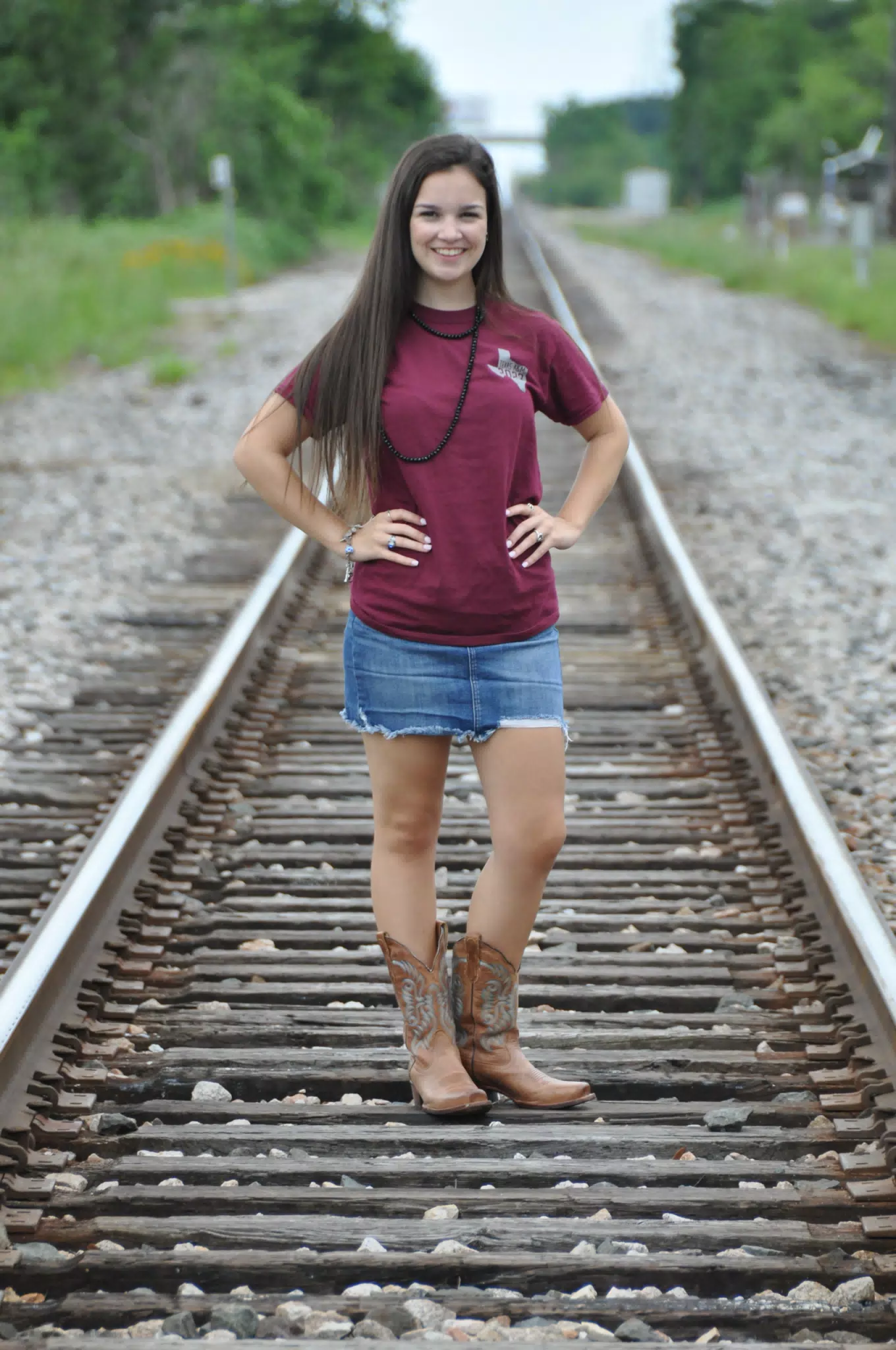 Emily in Skirt and Boots on Railroad Tracks in Texas