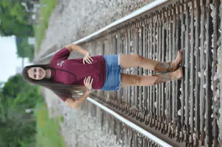 Emily in Skirt and Boots on Railroad Tracks in Texas