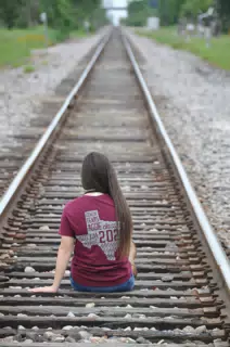 Emily Looking Away on Railroad Tracks