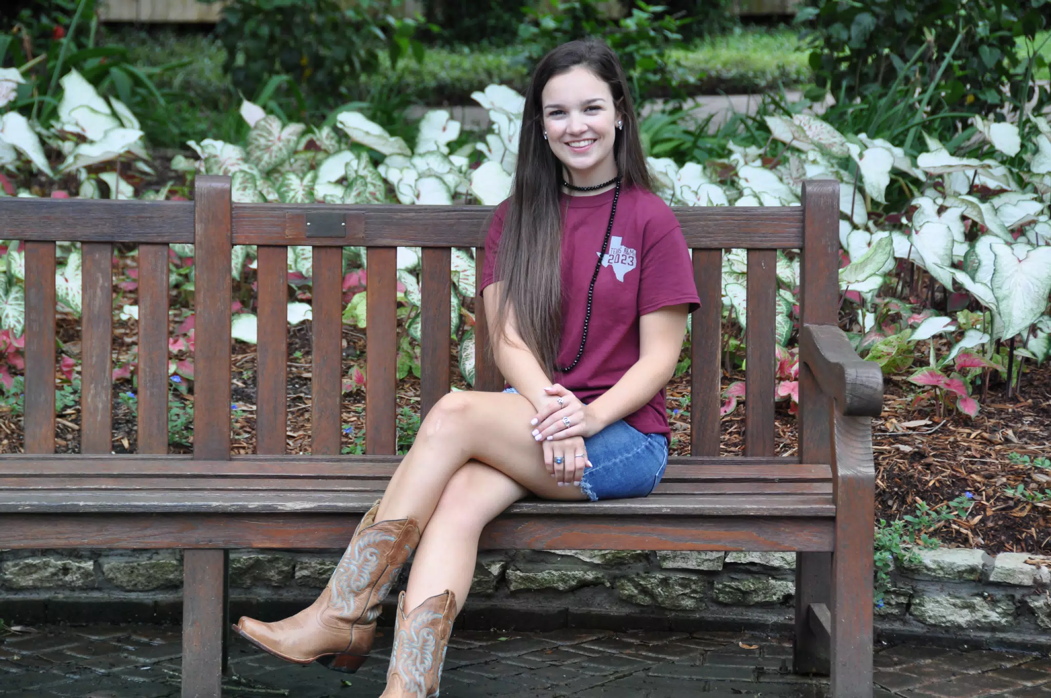 Emily on Park Bench in Jean Skirt and Cowgirl Boots