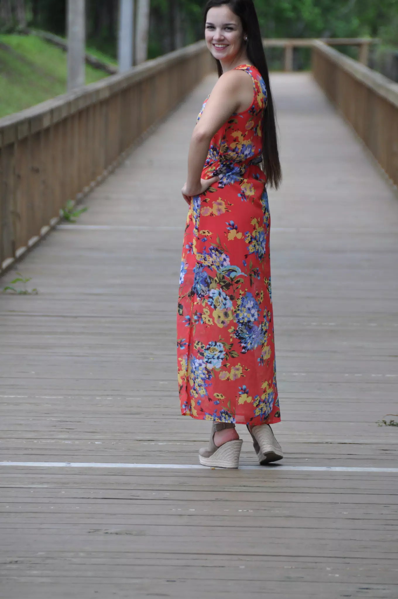 Model Looking Back Over Shoulder in Red Dress and Wedge Heels