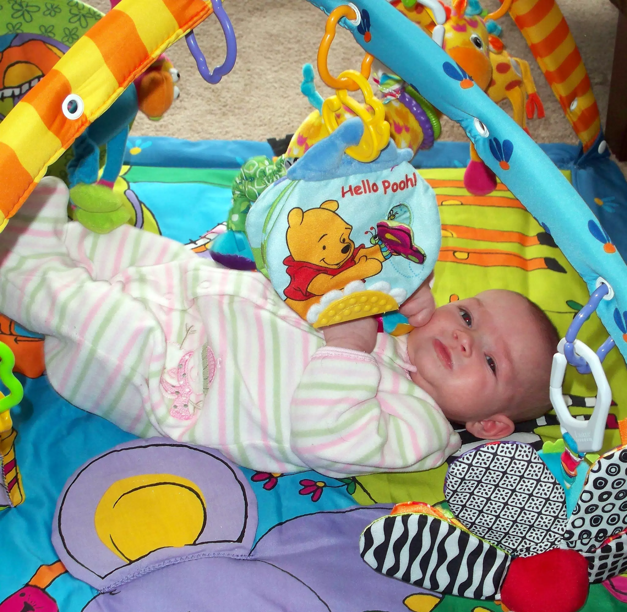 Liesl Playing with Pooh on Her Playmat