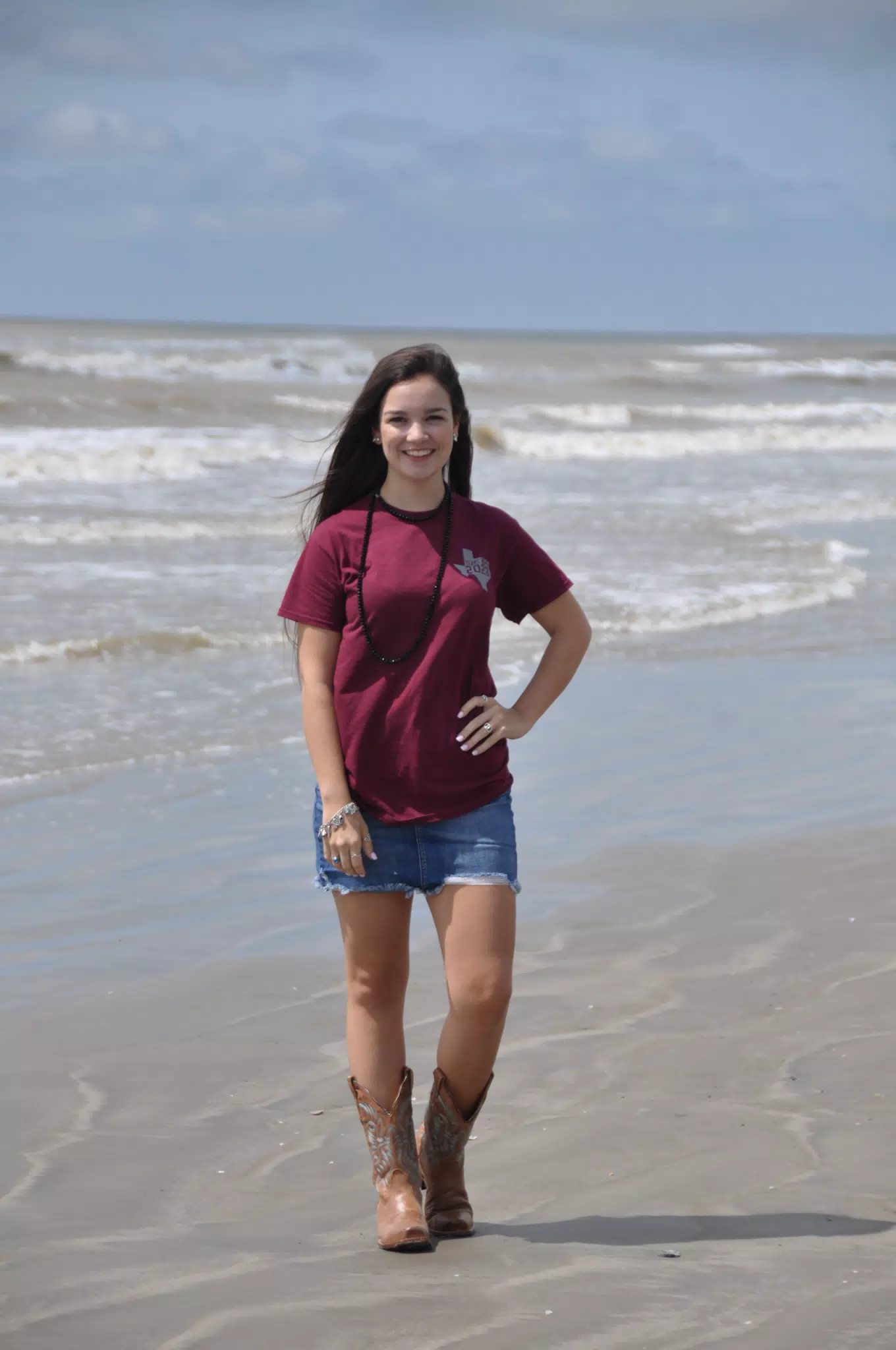 Emily Posing on Galveston Beach in Cowboy Boots