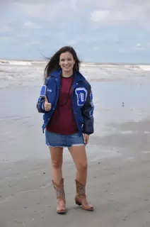 Brunette in Miniskirt Modeling on Beach with Cowboy Boots