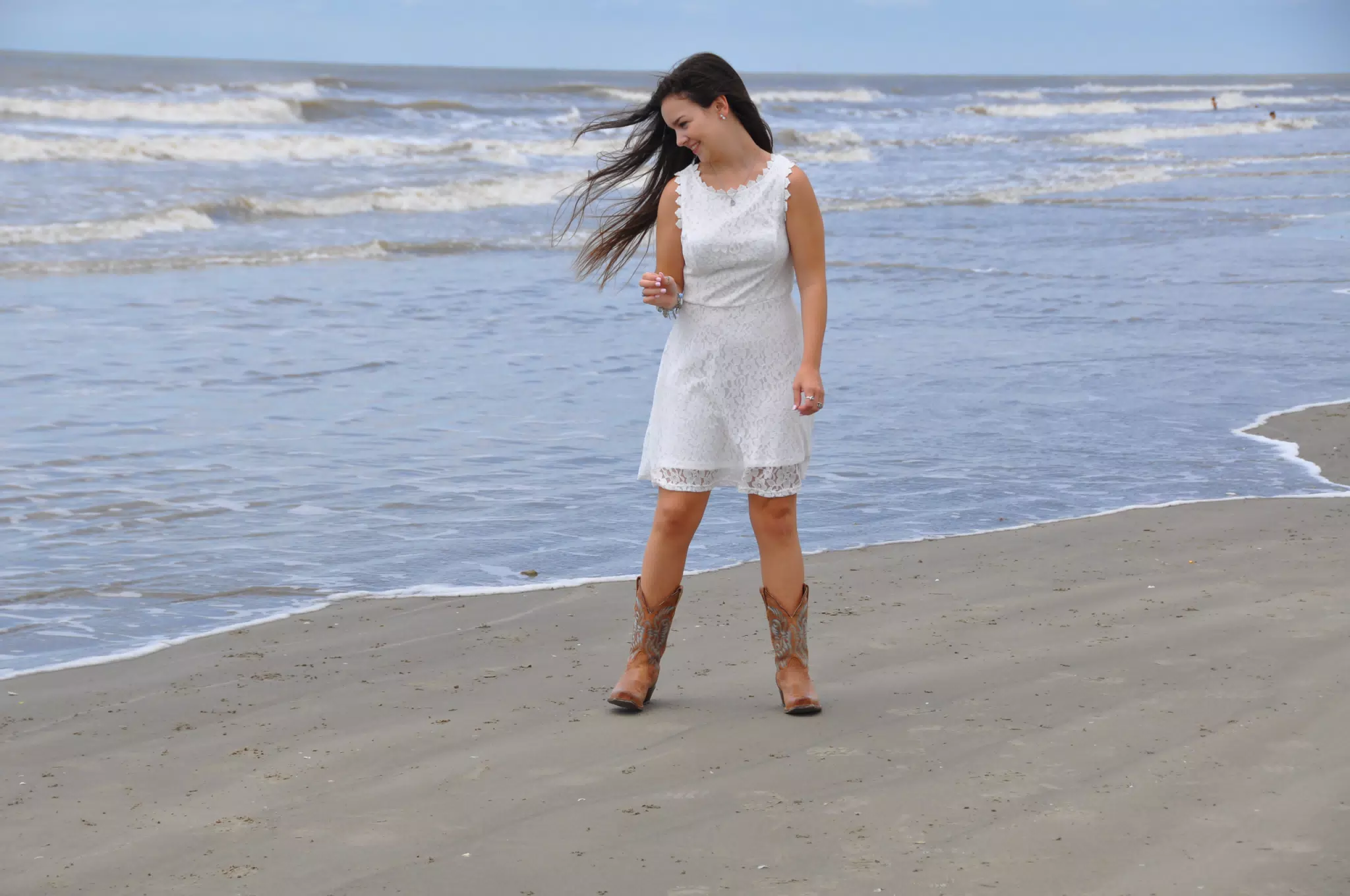 Emily in White Dress on Galveston Eyeing the Water with Suspicion