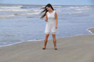 Emily in White Dress on Galveston Eyeing the Water with Suspicion
