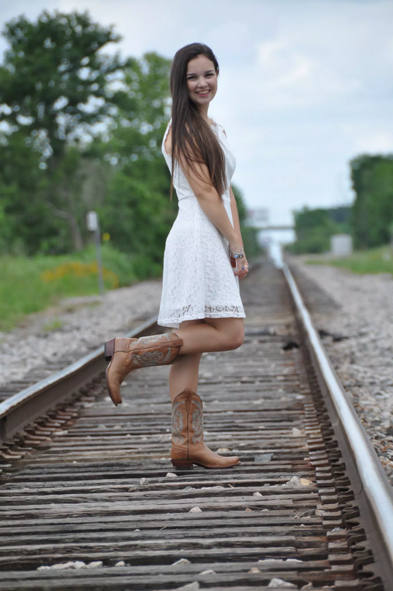 Brunette Model, White Dress, Railroad Tracks in Texas Wearing Cowboy Boots