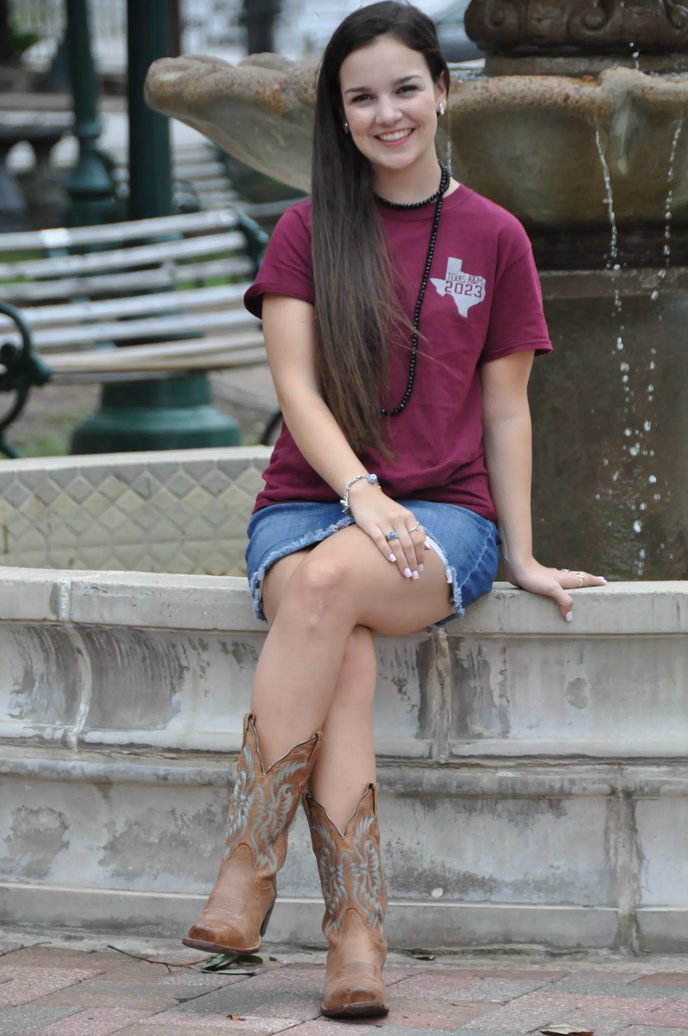 Emily Sitting on Fountain in Galveston, Texas in Cowboy Boots