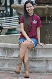 Emily Sitting on Fountain in Galveston, Texas in Cowboy Boots