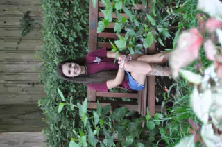 Brunette Model on Park Bench in Jean Skirt with Legs Crossed