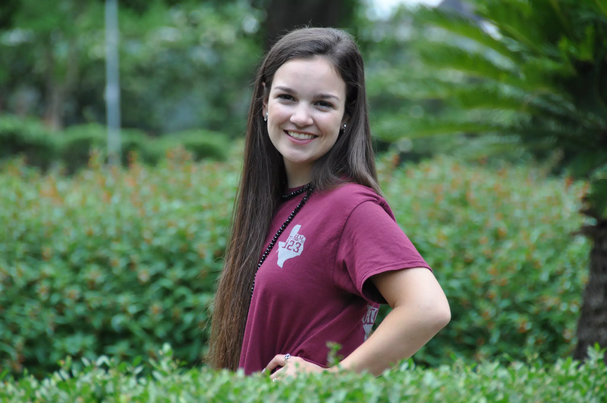 Brunette Posing by Hedge