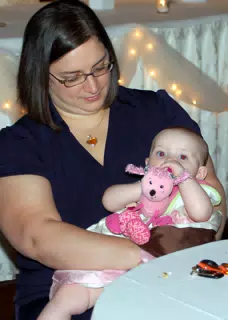 Dominica Holding Liesl at Table