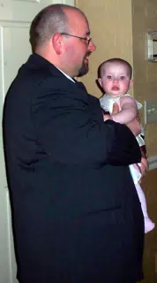 Scott holding Liesl at Wedding