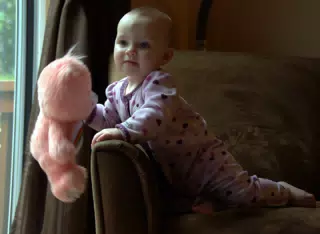 Liesl Playing with Cheer Bear