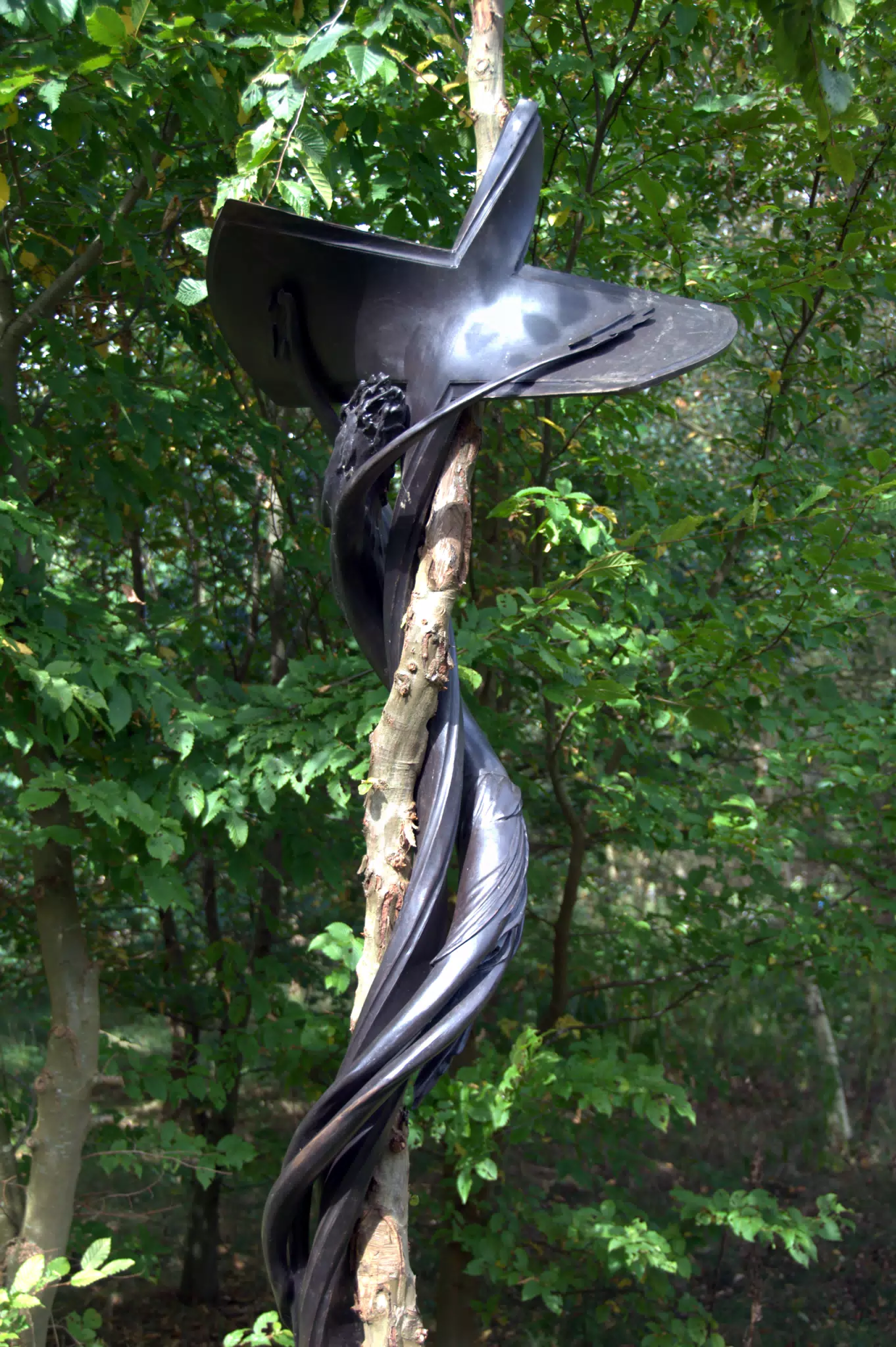 Artistic Cross Sculpture on Forest Path