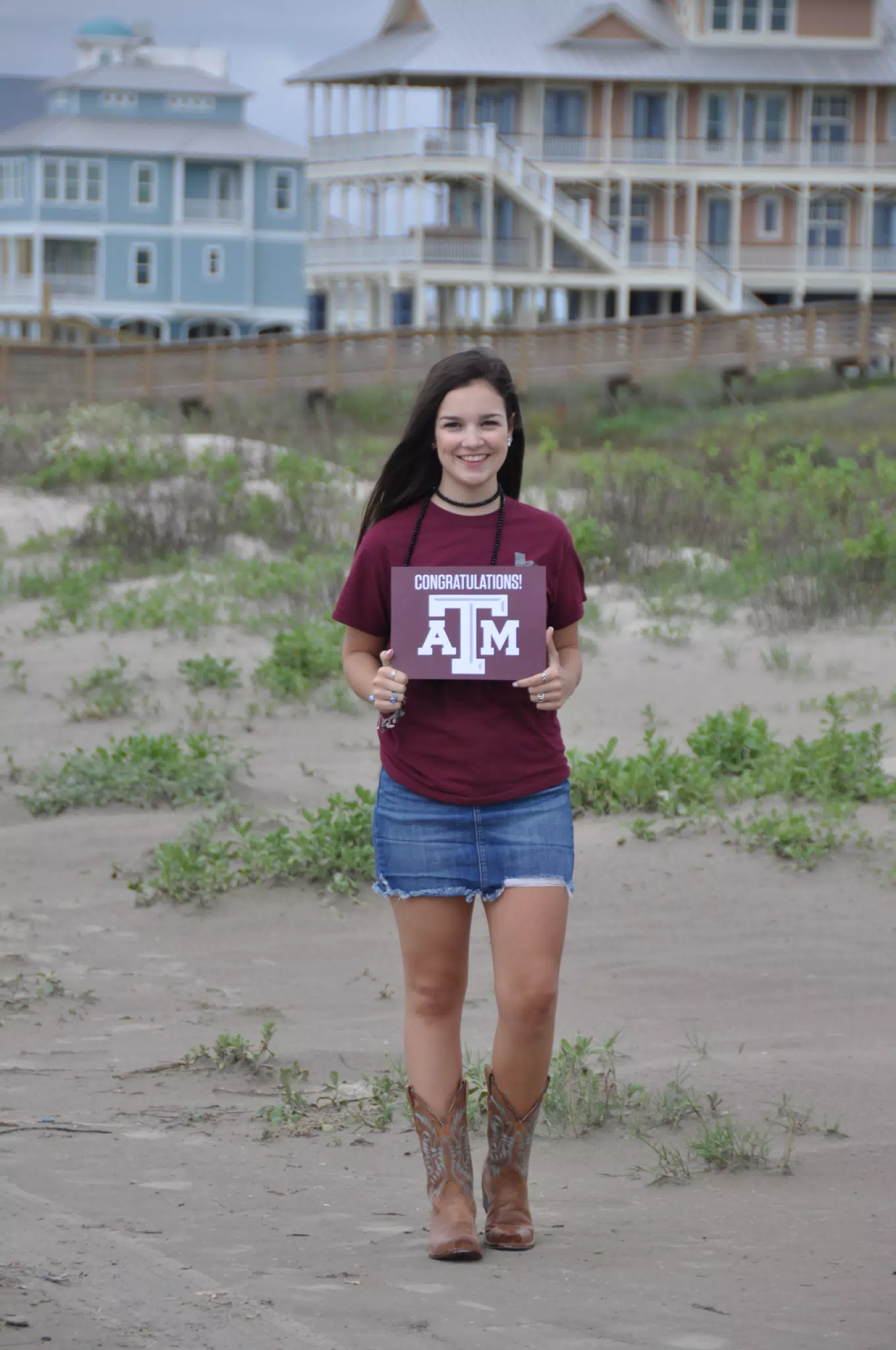 Teen Coed in Jean Miniskirt on Galveston Beach in Cowgirl Boots with Texas A&M Sign