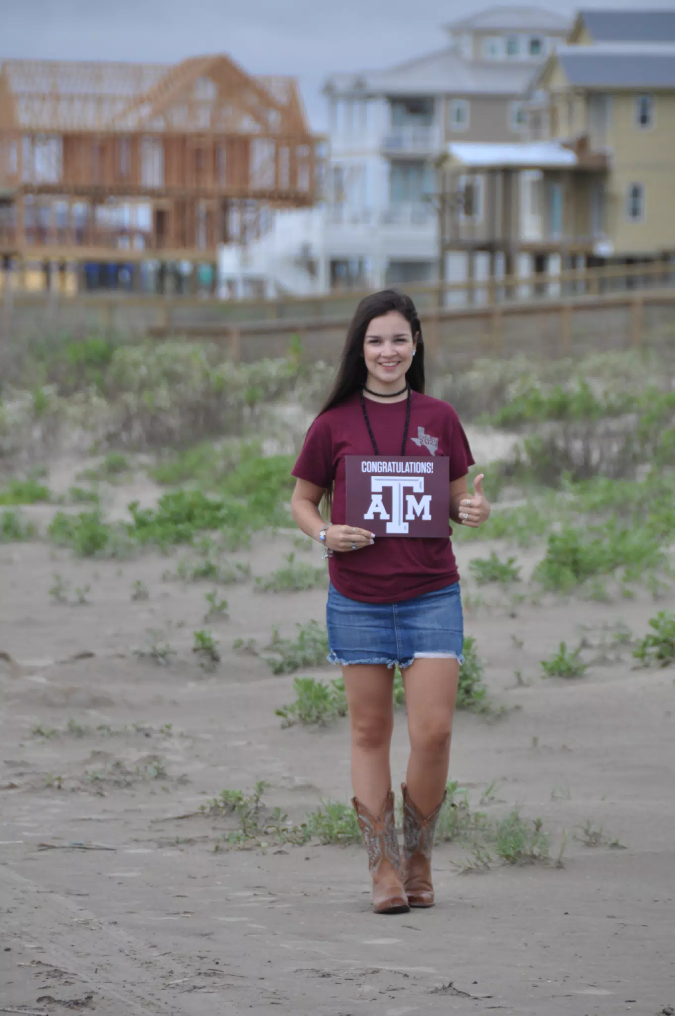 Emily Thumbs Up in Skirt and Boots on Galveston Beach