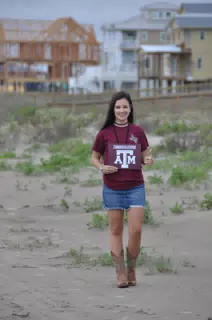 Emily Thumbs Up in Skirt and Boots on Galveston Beach