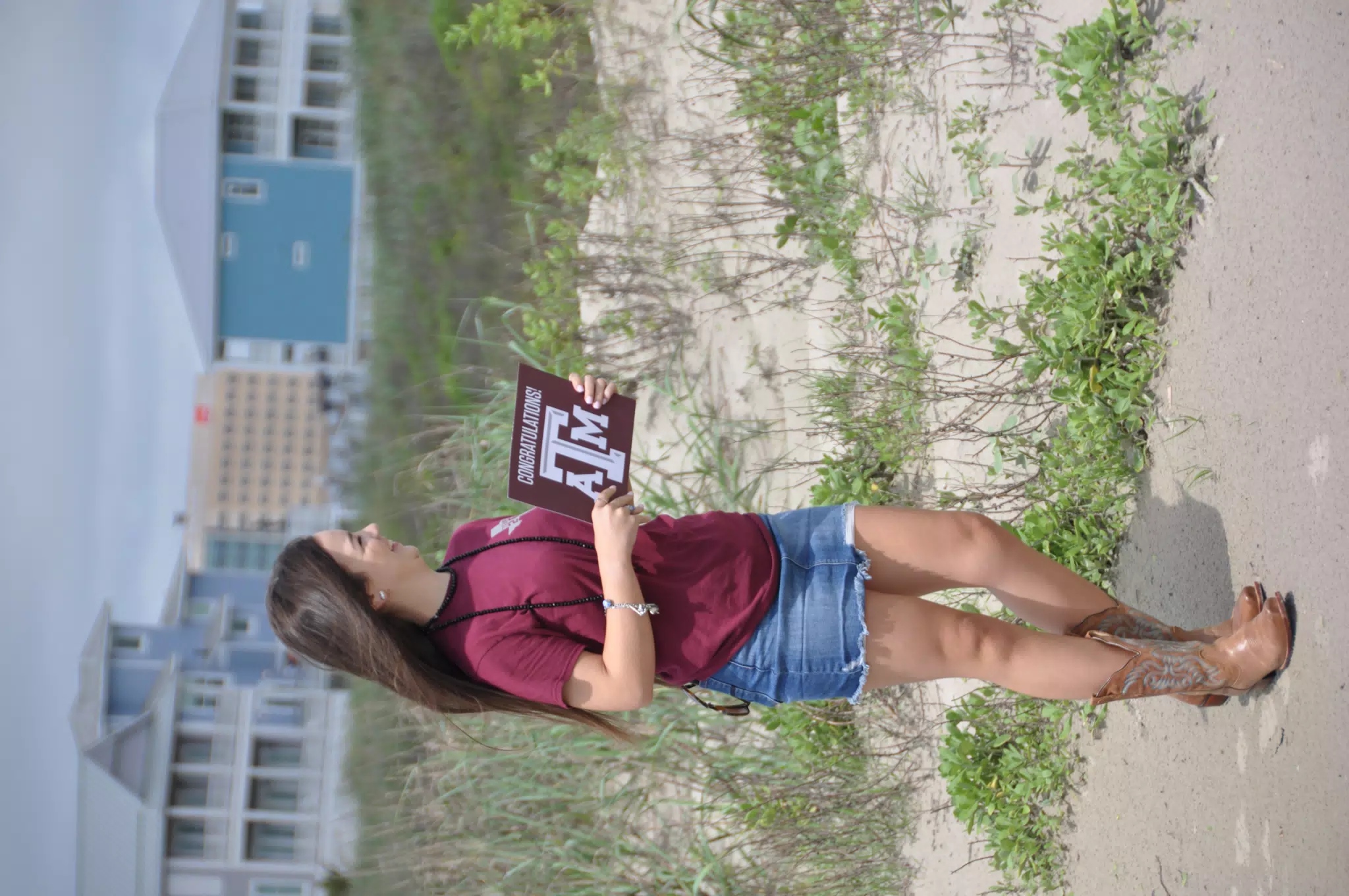 Emily with Sign on Galveston Beach
