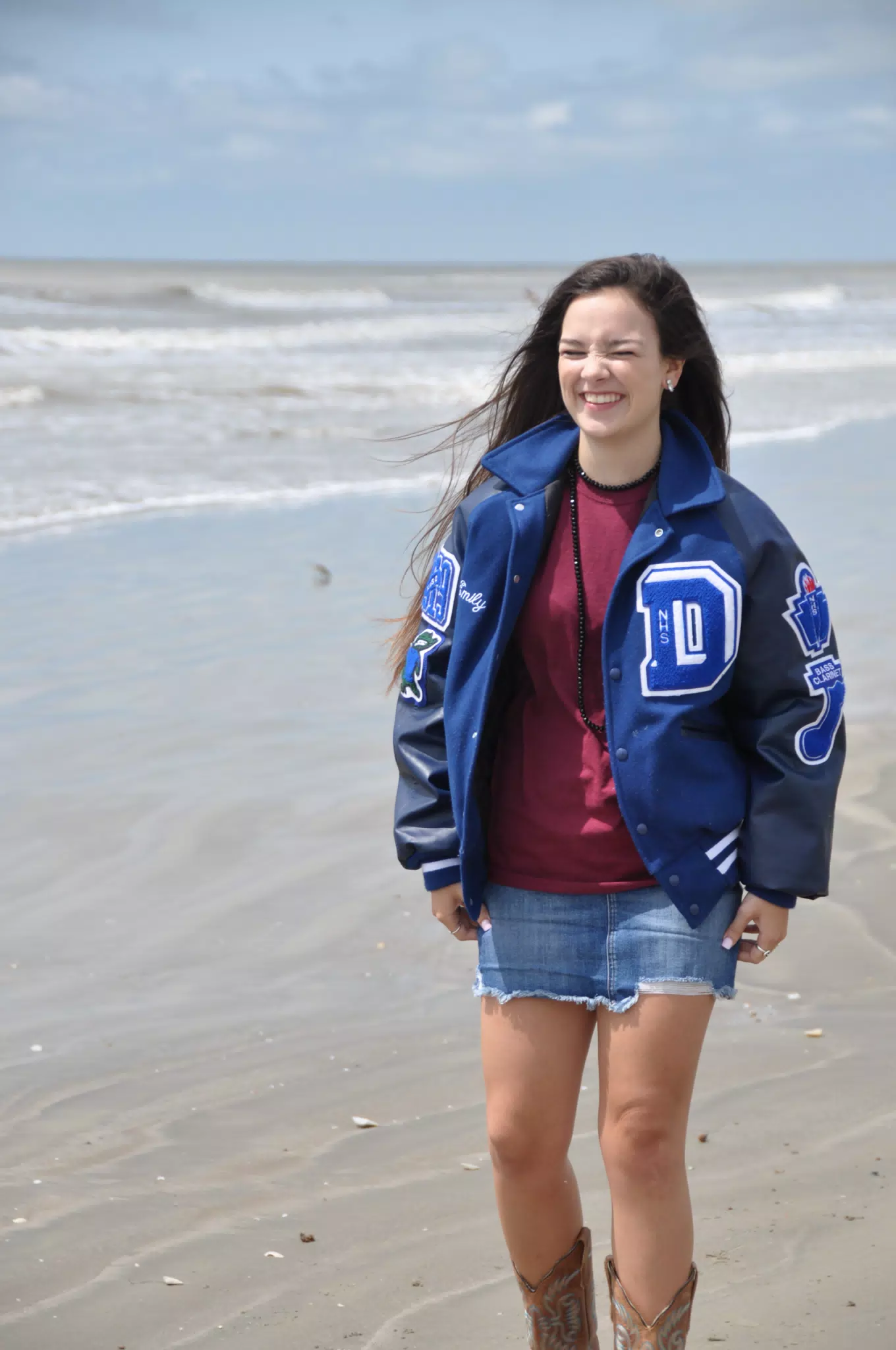Model Laughing on Beach in Photoshoot, Jean Skirt and Cowgirl Boots, Brunette Teen