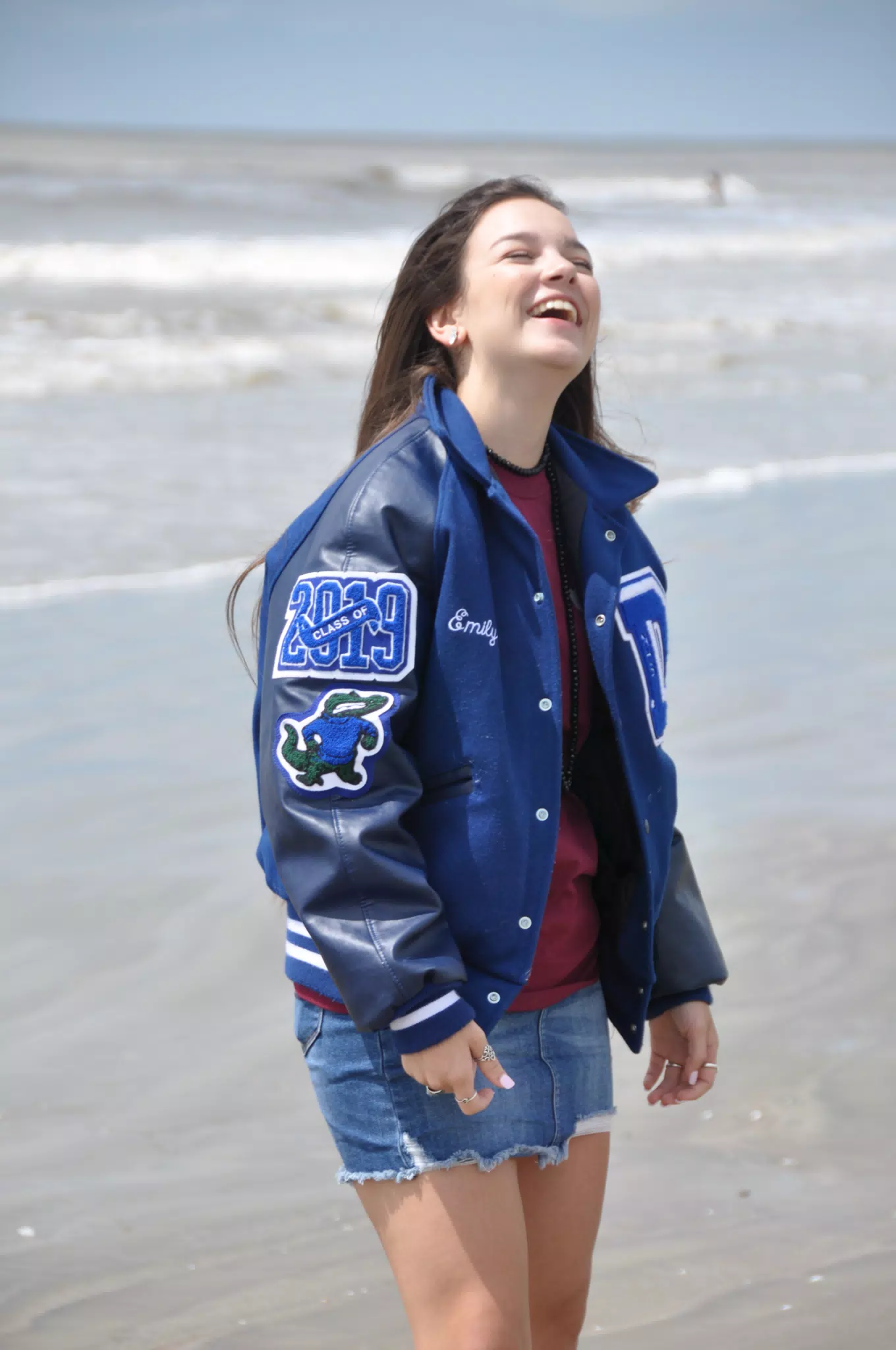 Teen Model Laughing on Galveston Beach in Letterman Jacket and Miniskirt