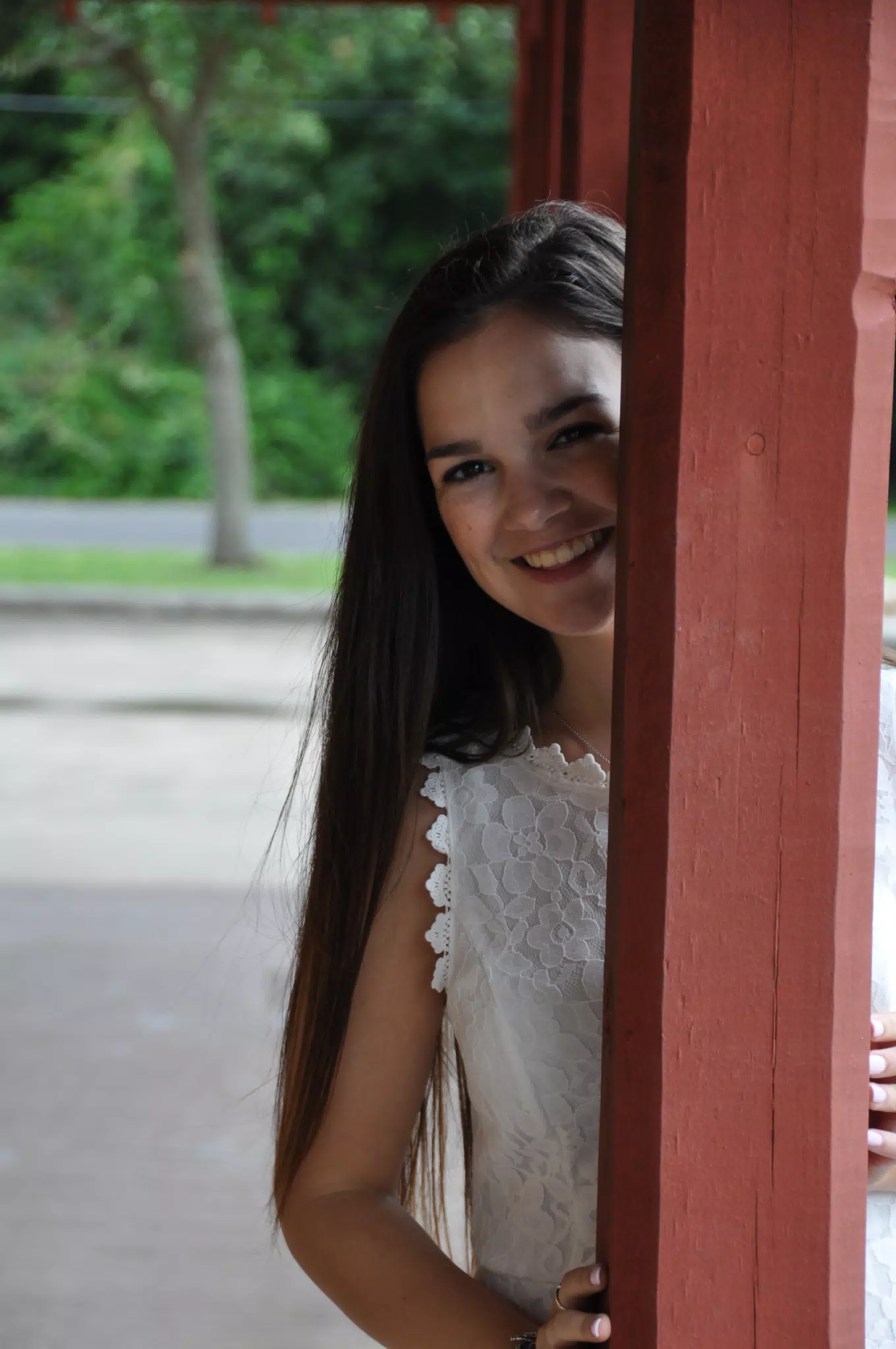 Teen Brunette Model Behind Post with Smile