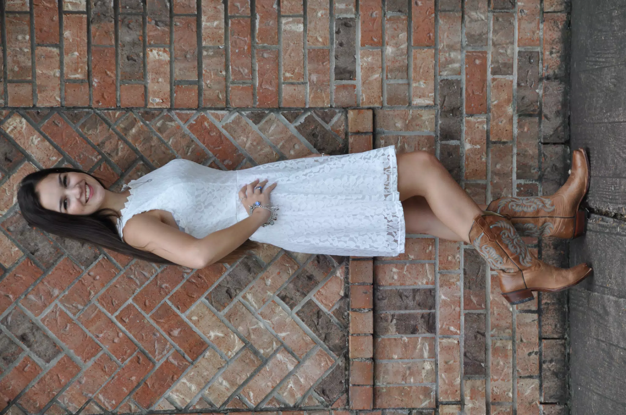 Teen in White Dress and Boots by Brick Wall Texas