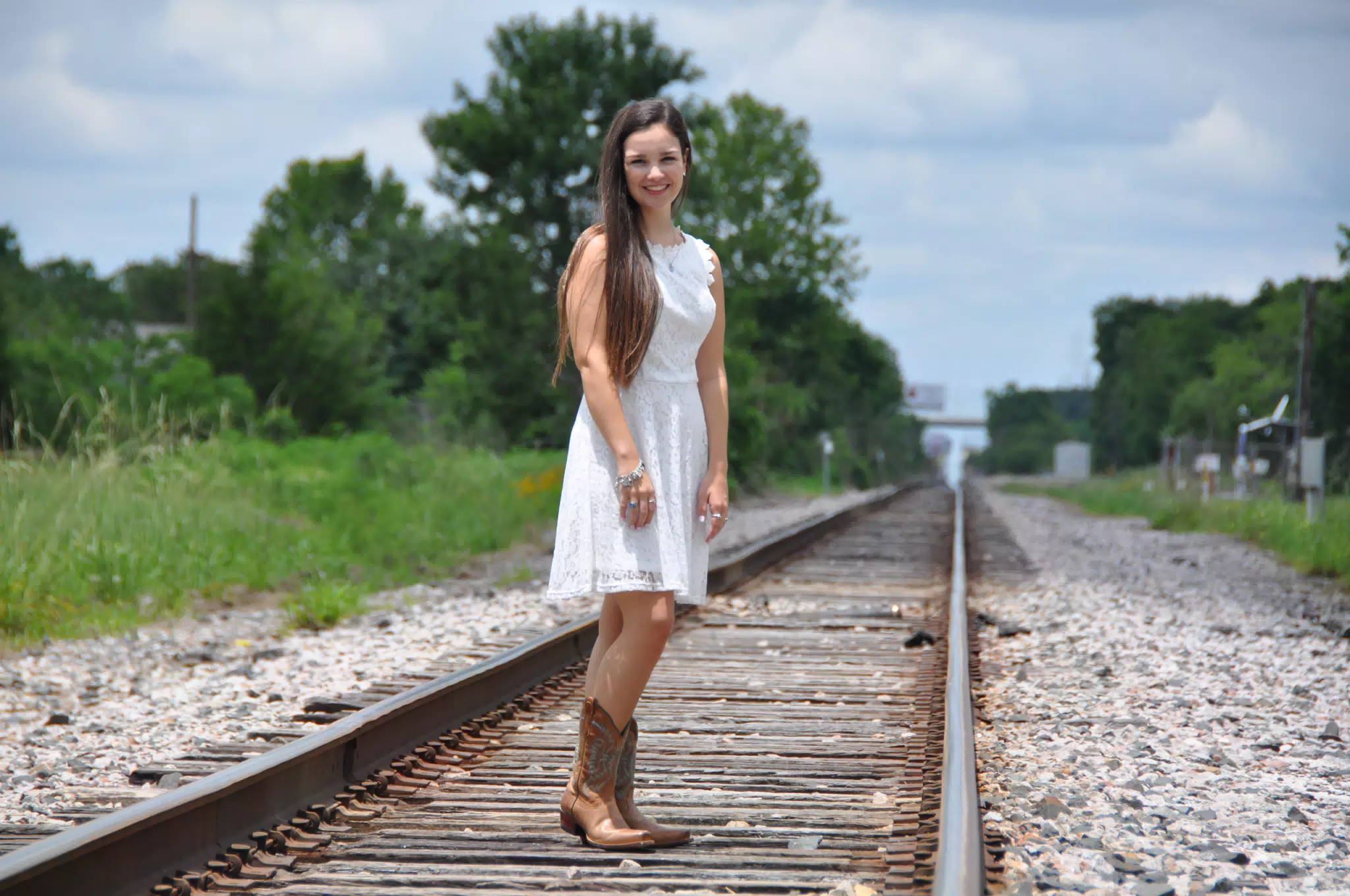 Emily in White Dress and Cowboy Boots on Railroad Tracks in Texas