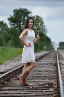 Model in White Dress on Railroad Tracks in Texas