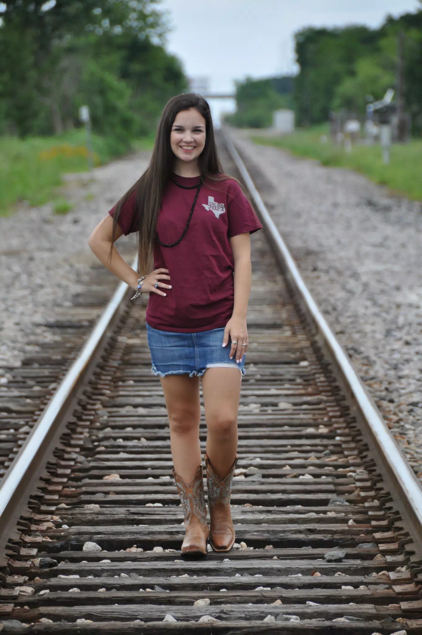 Model in Short Denim Skirt on Railroad Tracks