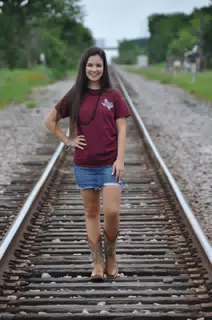 Model in Short Denim Skirt on Railroad Tracks