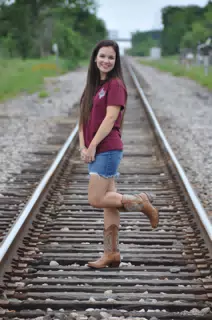 Teen Model Emily in Western Boots and Jean Skirt on Railroad Tracks in Houston Texas