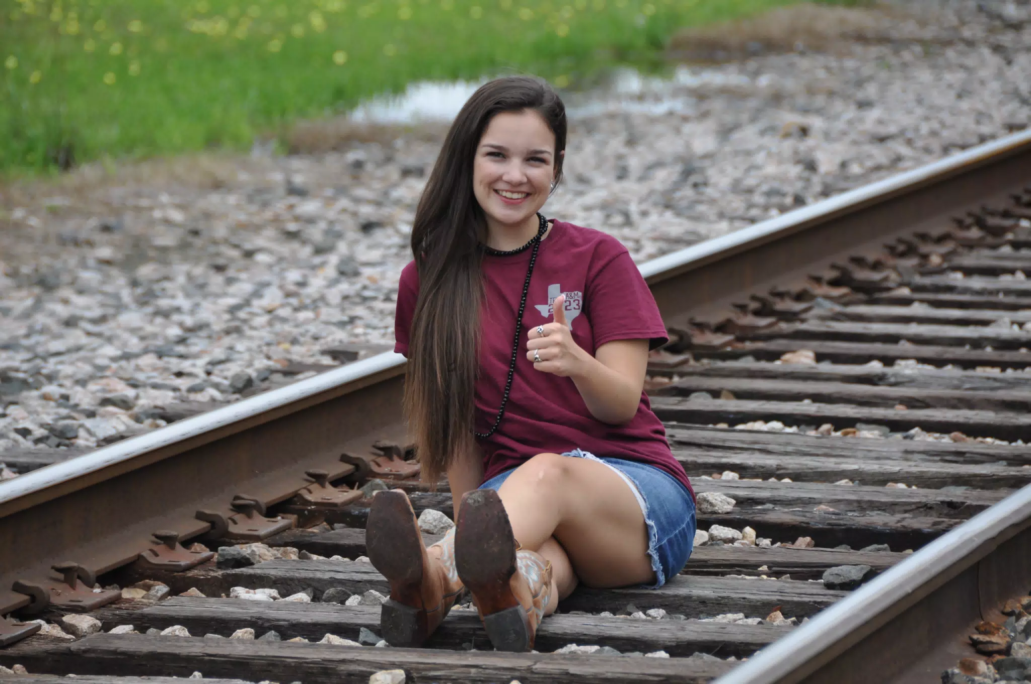 Brunette Model on Train Tracks in Denim Skirt