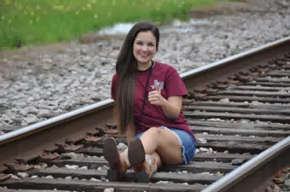 Brunette Model on Train Tracks in Denim Skirt