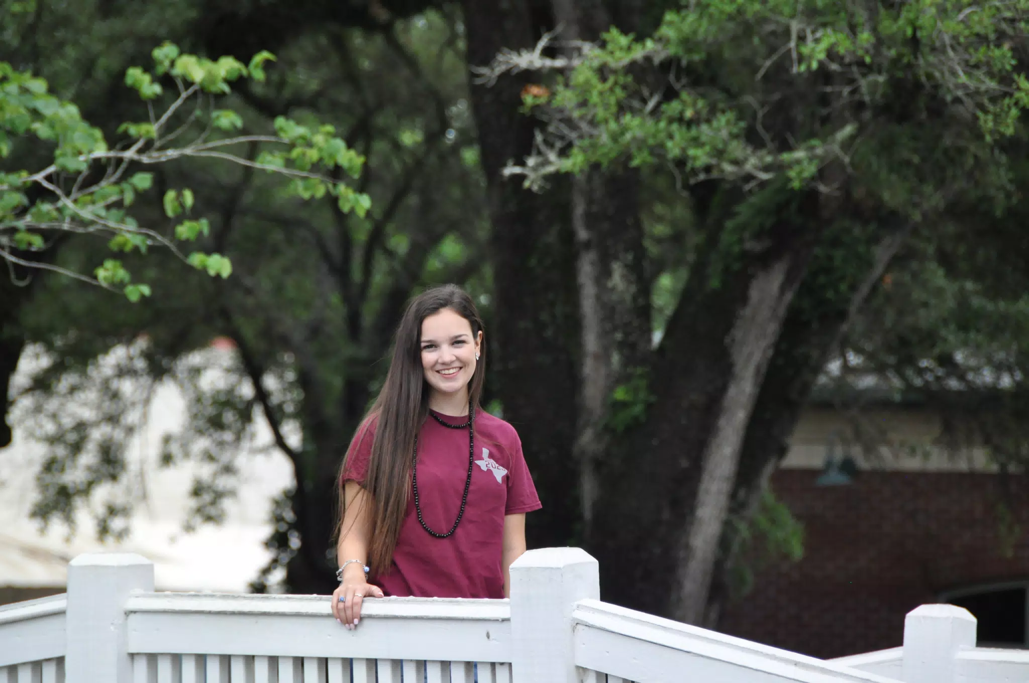 Brunette Model Standing on White Bridge Smiling